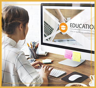 Woman uses a computer with the word education on the screen