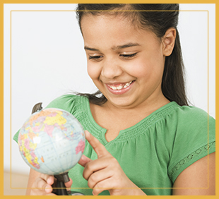 Smiling student touching a globe